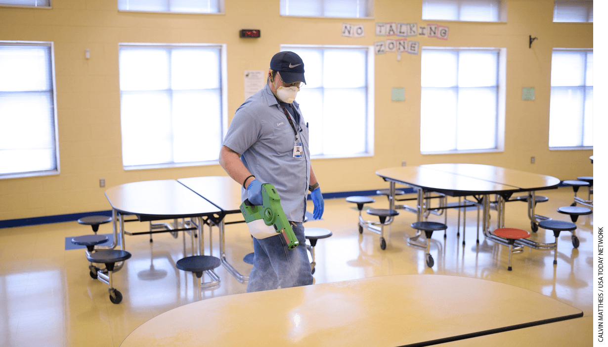 Knox County Schools worker Lonnie Johnson sanitizes the cafeteria with an electrostatic sprayer at Brickey-McCloud Elementary in Knoxville, Tenn., on Friday, March 13, 2020.