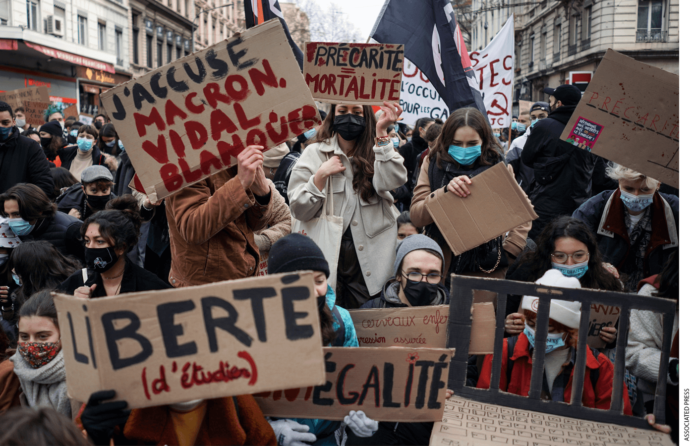 Students hold banners during a demonstration to demand support for workers, in Lyon, central France, Tuesday, Jan. 26, 2021.